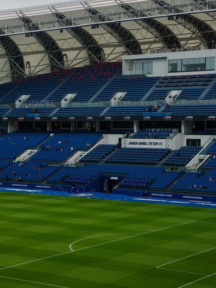 about-02 An empty football stadium showcasing the seating sections at Johor Darul Ta'zim FC in Malaysia.